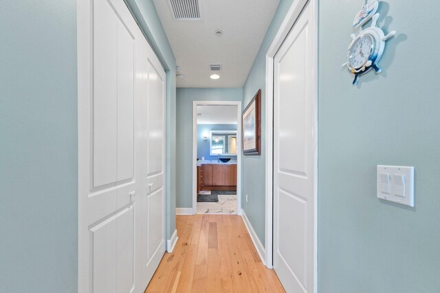 309 E Ocean Ave Unit 103, Lantana, FL 33462 - hall with baseboards, light wood-type flooring, and visible vents