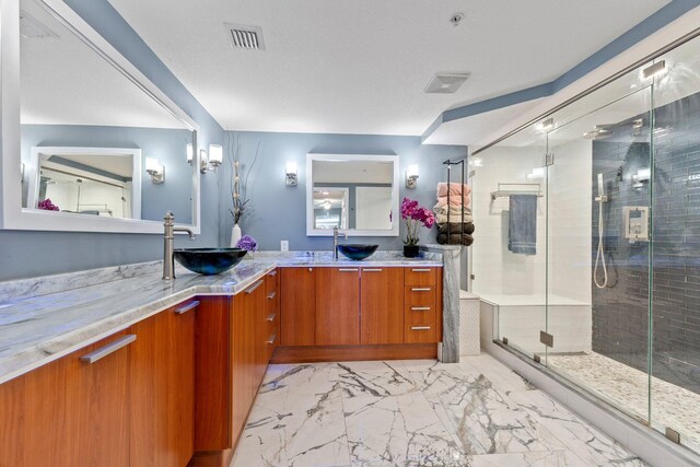 309 E Ocean Ave Unit 103, Lantana, FL 33462 - full bath featuring visible vents, a shower stall, marble finish floor, double vanity, and a sink