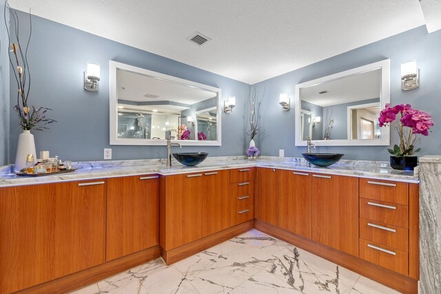 309 E Ocean Ave Unit 103, Lantana, FL 33462 - full bath with marble finish floor, a sink, double vanity, and visible vents