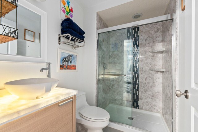 309 E Ocean Ave Unit 103, Lantana, FL 33462 - full bathroom featuring toilet, vanity, and a stall shower