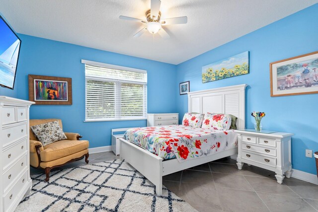 309 E Ocean Ave Unit 103, Lantana, FL 33462 - tiled bedroom with a ceiling fan and baseboards