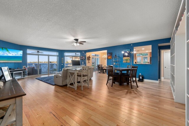 309 E Ocean Ave Unit 103, Lantana, FL 33462 - living area with light wood-style flooring, ceiling fan, and a textured ceiling