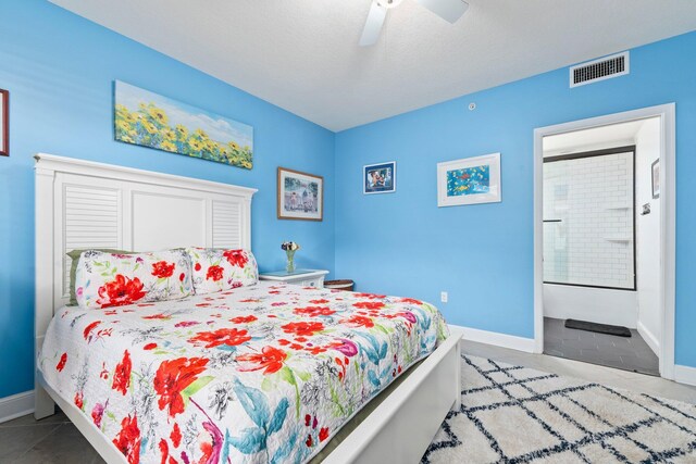 309 E Ocean Ave Unit 103, Lantana, FL 33462 - tiled bedroom featuring connected bathroom, baseboards, ceiling fan, and visible vents