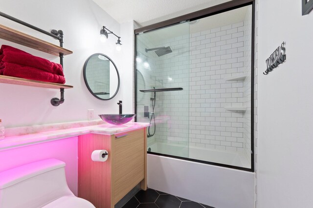 309 E Ocean Ave Unit 103, Lantana, FL 33462 - full bathroom with toilet, tile patterned floors, vanity, and shower / bath combination with glass door