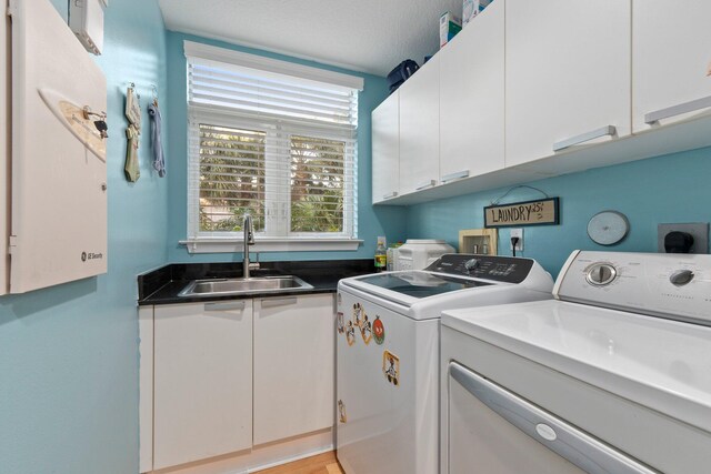 309 E Ocean Ave Unit 103, Lantana, FL 33462 - clothes washing area featuring a sink, cabinet space, and washing machine and dryer