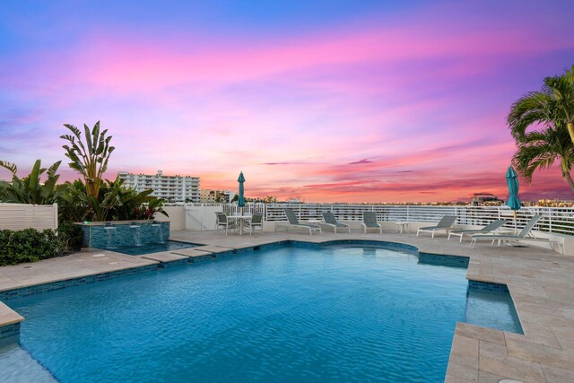 309 E Ocean Ave Unit 103, Lantana, FL 33462 - pool at dusk with an outdoor pool, fence, and a patio area