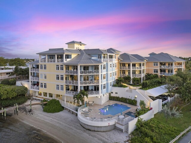 309 E Ocean Ave Unit 103, Lantana, FL 33462 - property at dusk with a fenced backyard and dirt driveway
