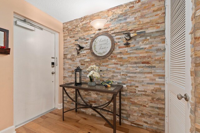 309 E Ocean Ave Unit 103, Lantana, FL 33462 - entryway featuring a textured ceiling and wood finished floors