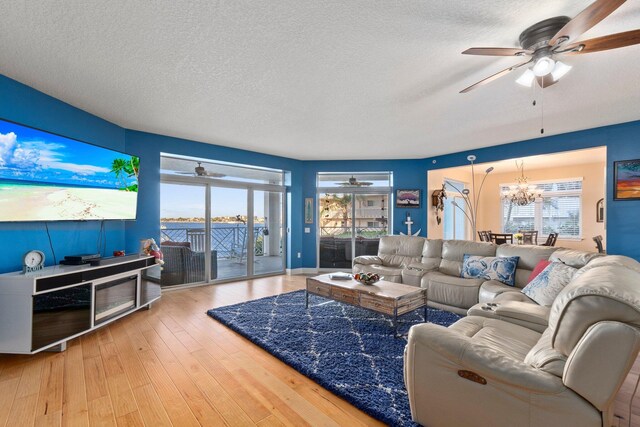 309 E Ocean Ave Unit 103, Lantana, FL 33462 - living room featuring hardwood / wood-style floors, a textured ceiling, and ceiling fan with notable chandelier