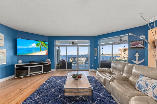 309 E Ocean Ave Unit 103, Lantana, FL 33462 - living area featuring a textured ceiling, ceiling fan, and wood finished floors