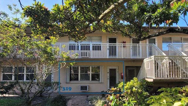 319 Chatham P, West Palm Beach, FL 33417 - view of front of house with stucco siding, stairs, and a balcony