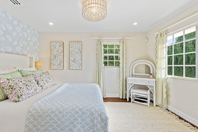 bedroom featuring recessed lighting, multiple windows, and wallpapered walls