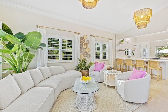 living area with a healthy amount of sunlight, crown molding, and vaulted ceiling