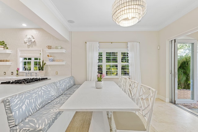 dining space featuring baseboards, a chandelier, and crown molding