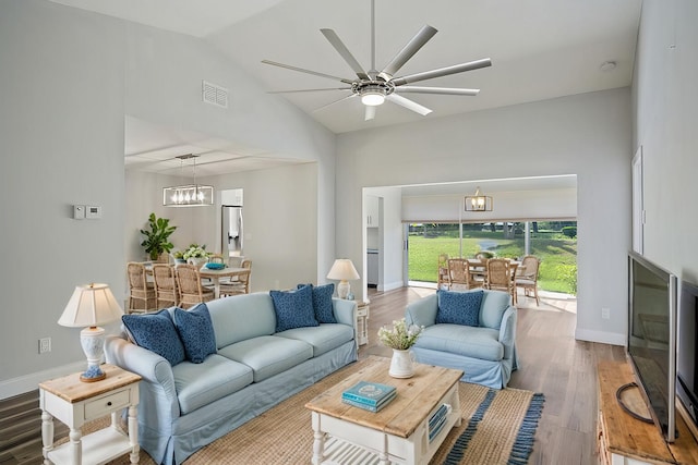 3362 SW Villa Pl, Palm City, FL 34990 - living room with visible vents, baseboards, vaulted ceiling, ceiling fan with notable chandelier, and wood finished floors