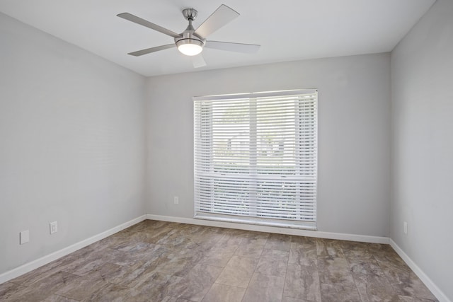 unfurnished room with baseboards and ceiling fan