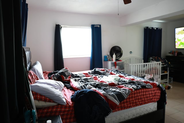 tiled bedroom with ceiling fan