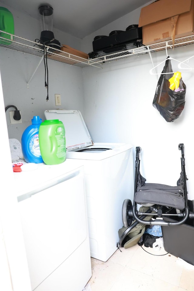 clothes washing area featuring independent washer and dryer and laundry area