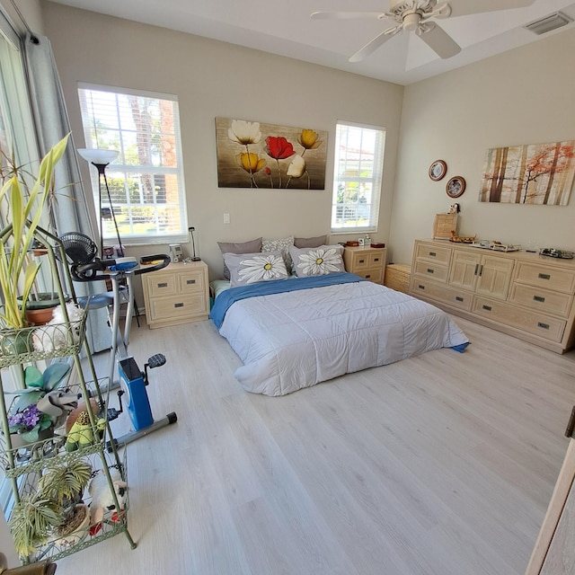 bedroom with visible vents and wood finished floors