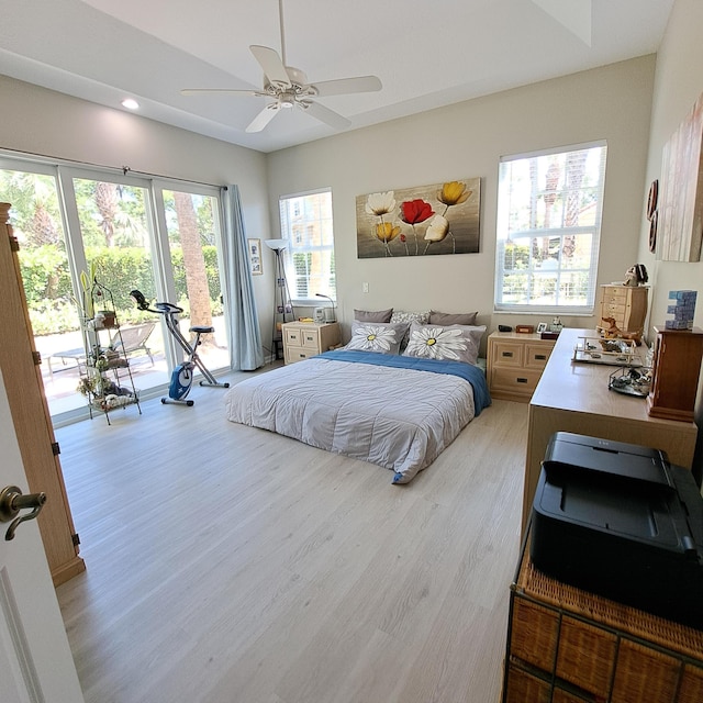 bedroom with light wood-style flooring, ceiling fan, and access to outside