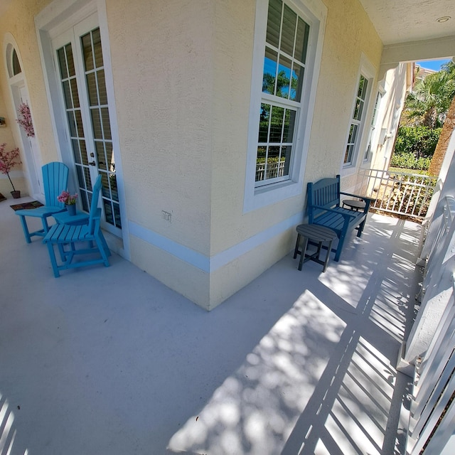 view of patio featuring covered porch and french doors