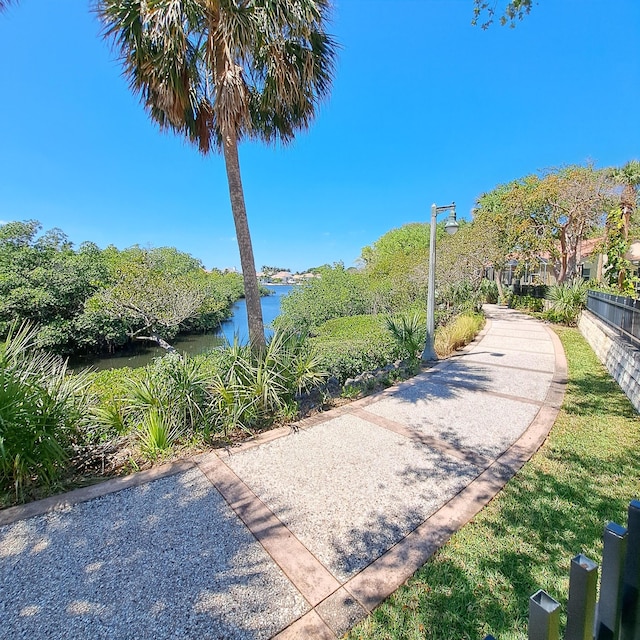 view of community featuring fence and a water view