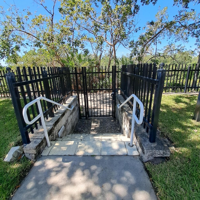 view of gate featuring a yard and fence