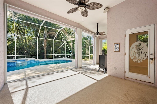 unfurnished sunroom featuring vaulted ceiling, a swimming pool, and a ceiling fan