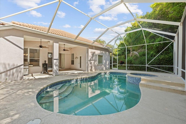 view of swimming pool with a patio, a lanai, a ceiling fan, and a pool with connected hot tub