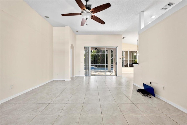 unfurnished room with light tile patterned floors, baseboards, arched walkways, and ceiling fan
