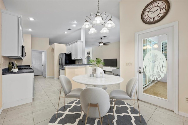 dining room featuring ceiling fan with notable chandelier, recessed lighting, arched walkways, light tile patterned floors, and baseboards