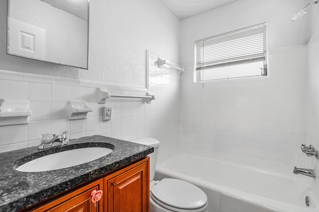 bathroom featuring tile walls, a wainscoted wall, toilet, shower / tub combination, and vanity