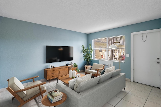 living area with light tile patterned floors and a textured ceiling