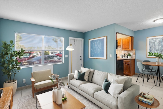 living room with light tile patterned floors, baseboards, and a textured ceiling