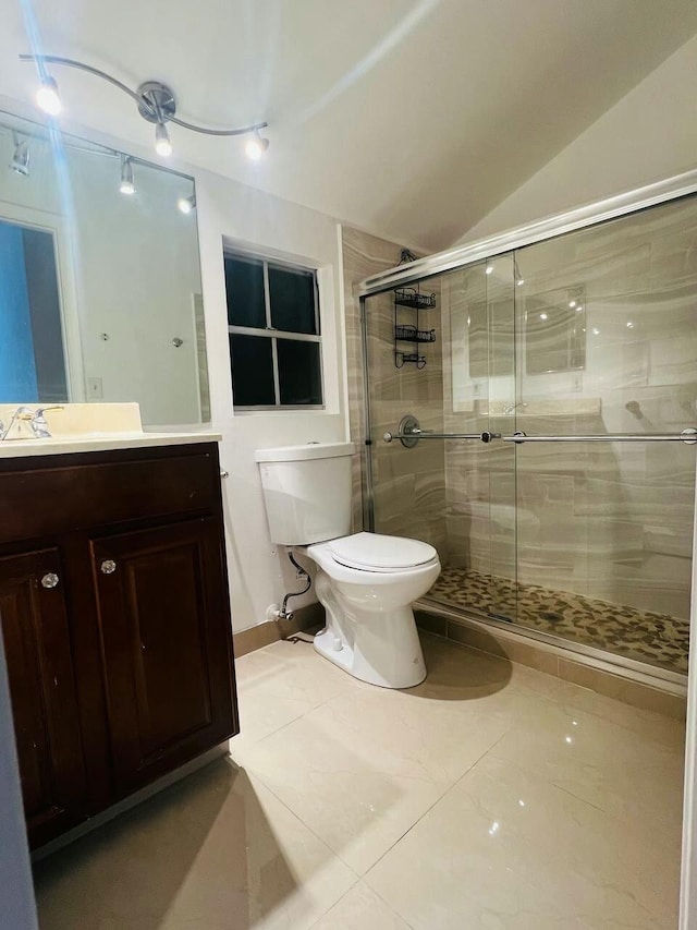 full bath featuring a stall shower, toilet, vanity, and vaulted ceiling