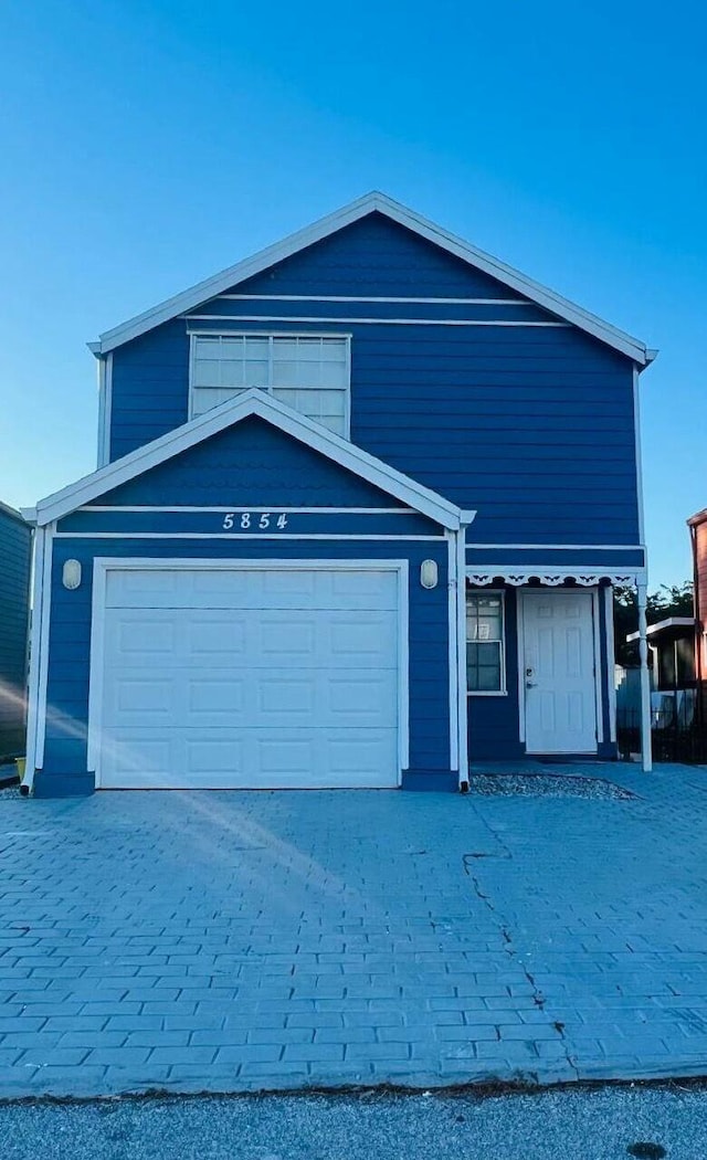 traditional-style home featuring driveway and an attached garage