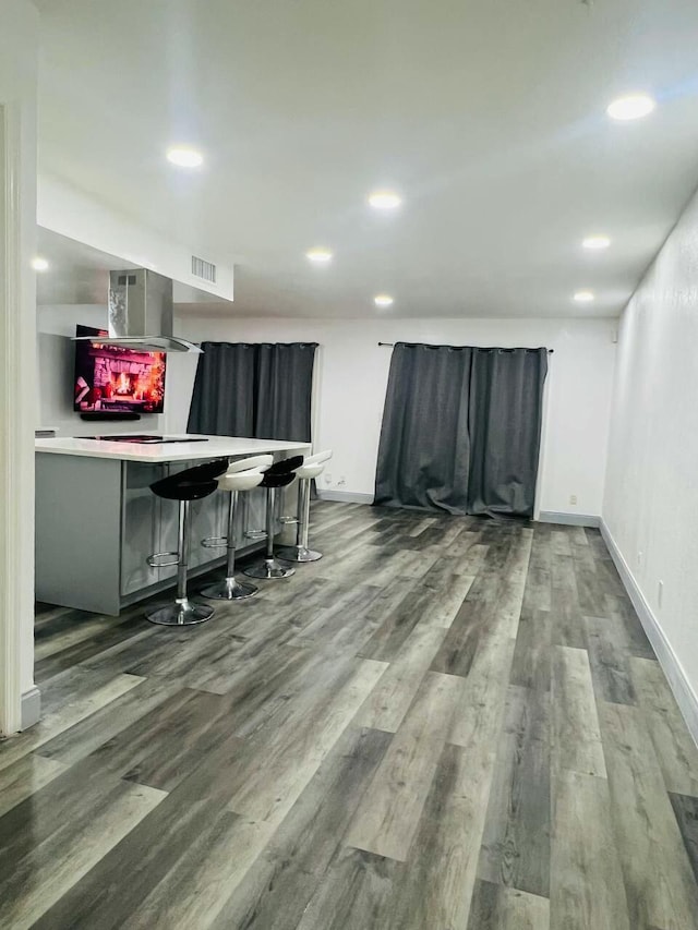 interior space featuring visible vents, recessed lighting, baseboards, and wood finished floors