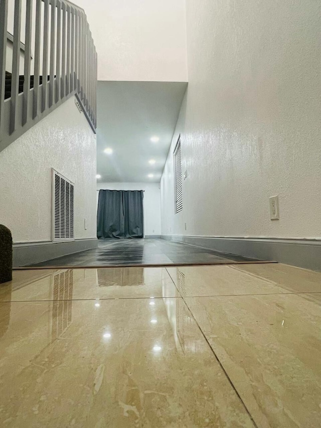 interior space with baseboards, visible vents, and marble finish floor