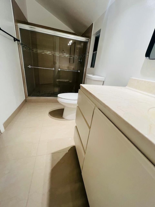 full bath featuring vanity, lofted ceiling, a stall shower, tile patterned floors, and toilet