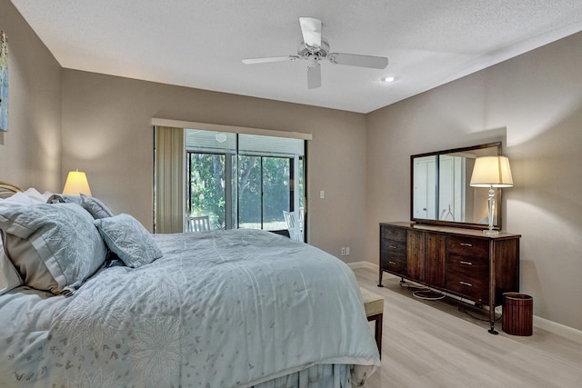 bedroom featuring light wood-style flooring, access to outside, a textured ceiling, baseboards, and ceiling fan