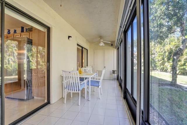 unfurnished sunroom featuring plenty of natural light and a ceiling fan