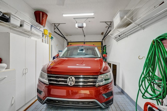 garage featuring a garage door opener and baseboards