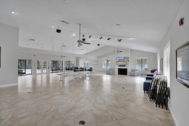 interior space featuring baseboards, a textured ceiling, and a ceiling fan