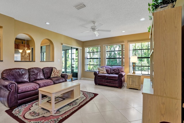 living room with visible vents, light tile patterned floors, recessed lighting, a textured ceiling, and a ceiling fan