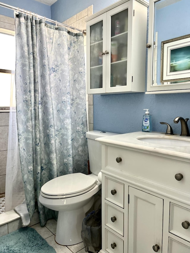 bathroom featuring a shower with curtain, tile patterned floors, toilet, and vanity