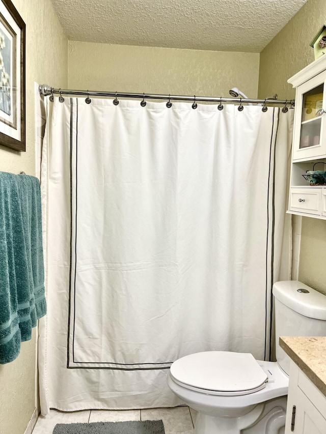 full bathroom featuring tile patterned flooring, curtained shower, toilet, a textured wall, and a textured ceiling