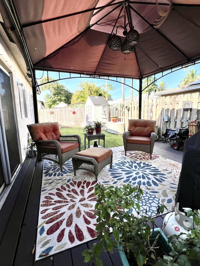 view of patio featuring a gazebo, an outbuilding, a storage shed, and fence