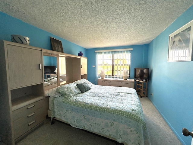 bedroom featuring carpet floors and a textured ceiling