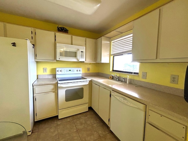 kitchen with white appliances, light countertops, tile patterned floors, and a sink