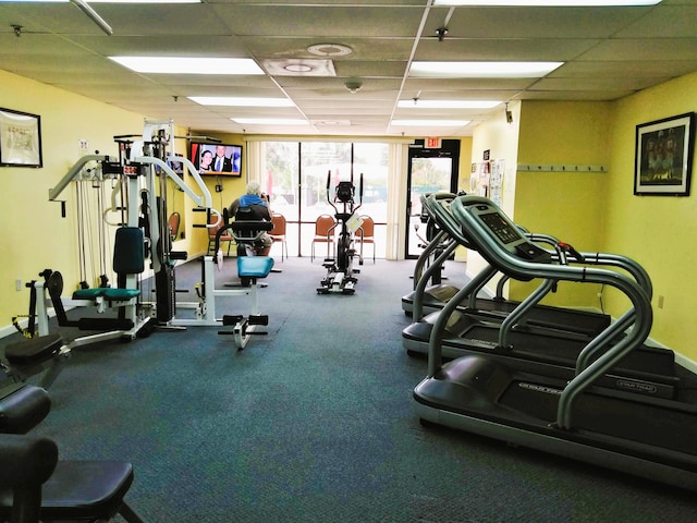 exercise room with a paneled ceiling